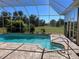 Sparkling, in-ground pool with spa, surrounded by a screened enclosure at 26453 Barranquilla Ave, Punta Gorda, FL 33983