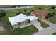 Single-story home with metal roof, large yard, and golf course views at 2325 Padre Island Dr, Punta Gorda, FL 33950