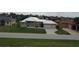 House with a metal roof, attached two-car garage, and a large yard at 2325 Padre Island Dr, Punta Gorda, FL 33950