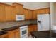 Bright kitchen with wood cabinets, granite counters, and modern appliances at 2325 Padre Island Dr, Punta Gorda, FL 33950