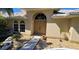 Front entrance with double doors and decorative landscaping at 27200 San Marino Dr, Punta Gorda, FL 33983