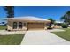 Tan two-car garage with light beige exterior at 27200 San Marino Dr, Punta Gorda, FL 33983