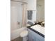 Bathroom with tub, toilet and a gray vanity at 26332 Barranquilla Ave, Punta Gorda, FL 33983