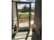 Screened porch entry with door and plants at 26332 Barranquilla Ave, Punta Gorda, FL 33983