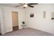 Bedroom with gray bedding, ceiling fan, and walk-in closet at 26332 Barranquilla Ave, Punta Gorda, FL 33983