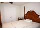 Bright bedroom featuring a wooden post bed and double doors at 26332 Barranquilla Ave, Punta Gorda, FL 33983