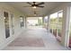 Screened porch with ceiling fans, hammock, and backyard view at 26332 Barranquilla Ave, Punta Gorda, FL 33983