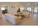 Open living room featuring comfortable sofas and high ceilings at 26332 Barranquilla Ave, Punta Gorda, FL 33983