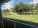 Backyard view from screened porch, featuring a grassy area at 26332 Barranquilla Ave, Punta Gorda, FL 33983