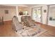 Relaxing living room with comfy armchairs and a large rug at 26332 Barranquilla Ave, Punta Gorda, FL 33983