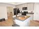 Modern kitchen with island and view into living room at 26332 Barranquilla Ave, Punta Gorda, FL 33983