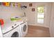 Laundry room with Samsung washer and dryer, utility sink and built in shelving at 26332 Barranquilla Ave, Punta Gorda, FL 33983