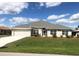 One-story home with gray roof and landscaping at 26332 Barranquilla Ave, Punta Gorda, FL 33983
