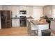 Modern kitchen with stainless steel appliances and breakfast bar at 26332 Barranquilla Ave, Punta Gorda, FL 33983