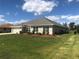 One-story home with gray roof and landscaping at 26332 Barranquilla Ave, Punta Gorda, FL 33983