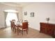 Bright dining room with a spacious table and hardwood floors at 26332 Barranquilla Ave, Punta Gorda, FL 33983