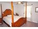 Spacious bedroom with a wooden post bed and carpet flooring at 26332 Barranquilla Ave, Punta Gorda, FL 33983
