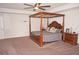 Spacious main bedroom with four poster bed and dresser at 26332 Barranquilla Ave, Punta Gorda, FL 33983