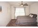 Bedroom with gray bedding, window coverings, and ceiling fan at 26332 Barranquilla Ave, Punta Gorda, FL 33983