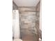 Walk-in shower with gray tile and built-in seat at 26332 Barranquilla Ave, Punta Gorda, FL 33983