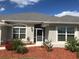 One-story home with gray roof and landscaping at 26332 Barranquilla Ave, Punta Gorda, FL 33983