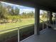 Backyard view from screened porch with grassy area and fence at 26332 Barranquilla Ave, Punta Gorda, FL 33983