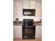 Modern kitchen with black appliances and dark countertops at 26332 Barranquilla Ave, Punta Gorda, FL 33983