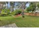 Relaxing backyard with hammock, lush grass, and mature trees at 4347 Randypaar St, Port Charlotte, FL 33948