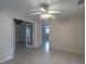 Spacious bedroom with tile floors and ceiling fan at 110 Bedford Ne Dr, Port Charlotte, FL 33952