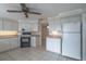 Galley kitchen with white cabinets and appliances at 110 Bedford Ne Dr, Port Charlotte, FL 33952