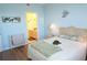 Relaxing bedroom with ensuite bathroom and light blue walls at 175 Kings Hwy # 923, Punta Gorda, FL 33983
