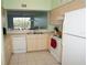 Well-equipped kitchen featuring white appliances and ample cabinetry at 175 Kings Hwy # 923, Punta Gorda, FL 33983