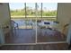 Screened balcony with table and chairs overlooking pond at 175 Kings Hwy # 923, Punta Gorda, FL 33983