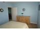 Bedroom with light-blue walls and dresser at 175 Kings Hwy # 923, Punta Gorda, FL 33983