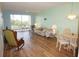 Living room with hardwood floors and access to a screened balcony at 175 Kings Hwy # 923, Punta Gorda, FL 33983