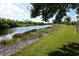 Serene canal view with grassy banks and vegetation at 175 Kings Hwy # 923, Punta Gorda, FL 33983