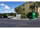 Building exterior with parking, mailboxes, and dumpster at 175 Kings Hwy # 923, Punta Gorda, FL 33983