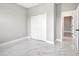 Bedroom with grey walls, white closet doors, and marble-look floors at 122 Jennifer Dr, Rotonda West, FL 33947