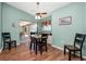 Light-filled dining area with pool views, complemented by wood-look floors and stylish decor at 1759 Nuremberg Boulevard, Punta Gorda, FL 33983