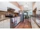 Well lit kitchen with stainless steel appliances and a view to the dining area at 1759 Nuremberg Boulevard, Punta Gorda, FL 33983