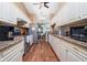 Bright kitchen with white cabinets, stainless steel appliances, and stone countertops at 1759 Nuremberg Boulevard, Punta Gorda, FL 33983