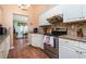 Well-lit kitchen featuring granite counters, stainless steel appliances and traditional white cabinetry at 1759 Nuremberg Boulevard, Punta Gorda, FL 33983