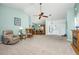 Large living room with a ceiling fan, and access to the dining room and foyer at 1759 Nuremberg Boulevard, Punta Gorda, FL 33983