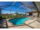 Inviting screened-in pool area with brick pavers and serene backyard views, perfect for relaxation and entertaining at 1759 Nuremberg Boulevard, Punta Gorda, FL 33983