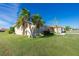 Tan house with palm trees and manicured lawn at 1759 Nuremberg Boulevard, Punta Gorda, FL 33983