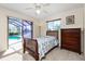 Bedroom with pool view and sliding glass doors at 1759 Nuremberg Boulevard, Punta Gorda, FL 33983