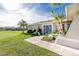 Side view of a house with a stone facade and a spacious lawn at 1759 Nuremberg Boulevard, Punta Gorda, FL 33983