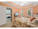 Bedroom with a queen bed and access to another room at 5127 Melbourne St # F-204, Port Charlotte, FL 33980