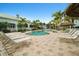 Relaxing pool area with lounge chairs and umbrellas at 5127 Melbourne St # F-204, Port Charlotte, FL 33980
