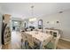 Coastal-themed dining room with white table and chairs, and hardwood floors at 5127 Melbourne St # F-204, Port Charlotte, FL 33980
